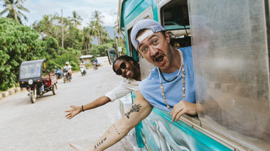 Travellers Waving from Jeepney on Road, Philippines